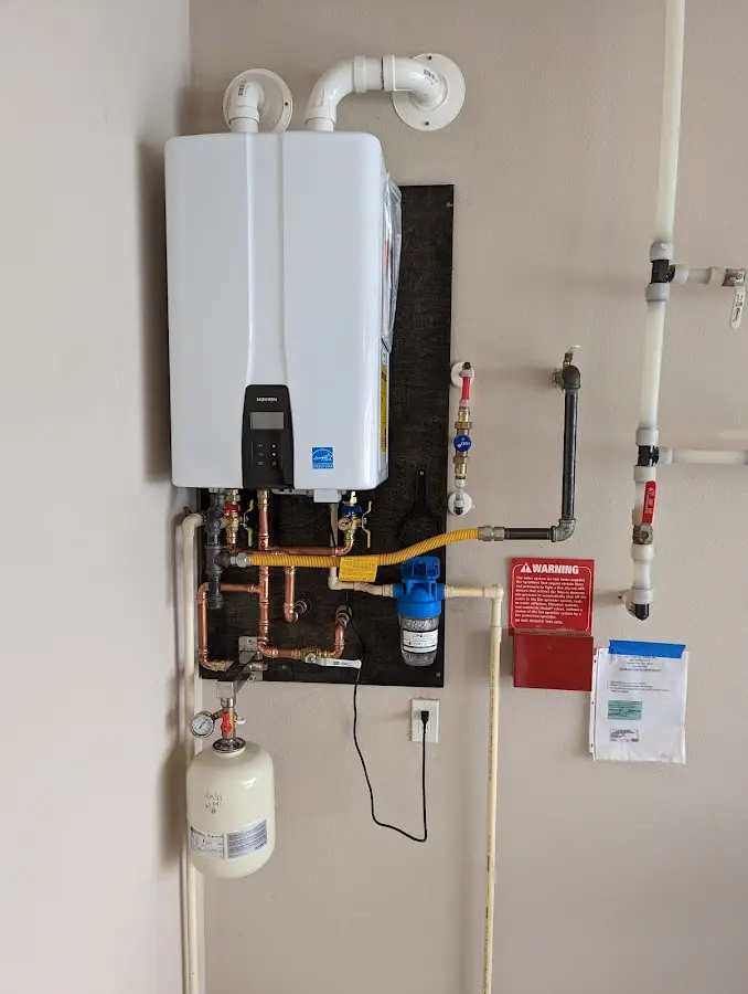 Professional plumber installing copper piping in a Rochelle home